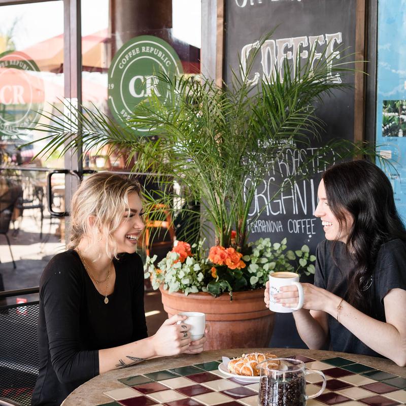 Guests sharing coffee on Coffee Republic's patio